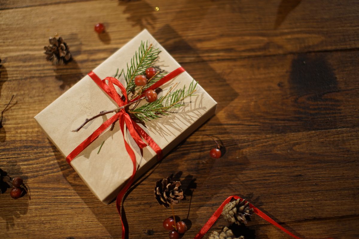 A real wrapped Christmas gift photographed on a wooden floor